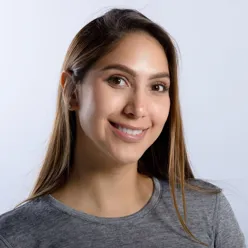 En kvinne som smiler til kameraet