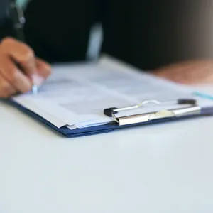 A person writing on a piece of paper