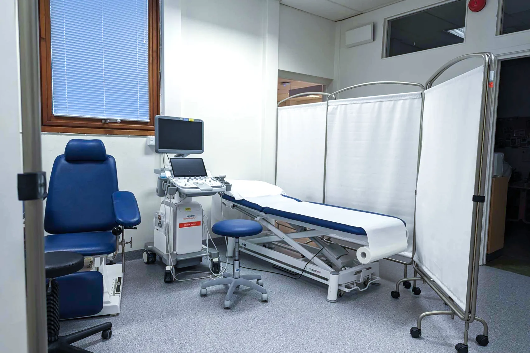A hospital room with a bed and medical equipment