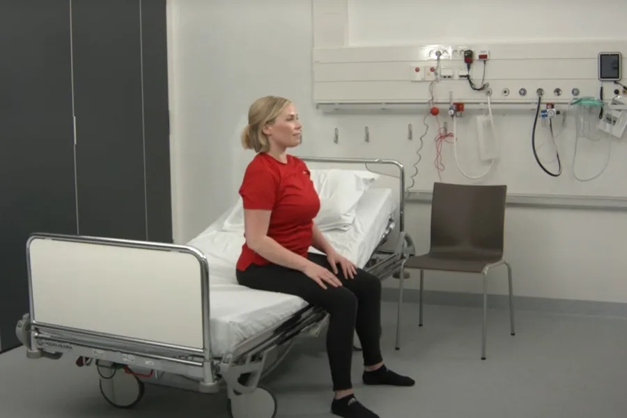 A person sitting in a hospital bed