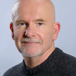 A bald man with a mustache