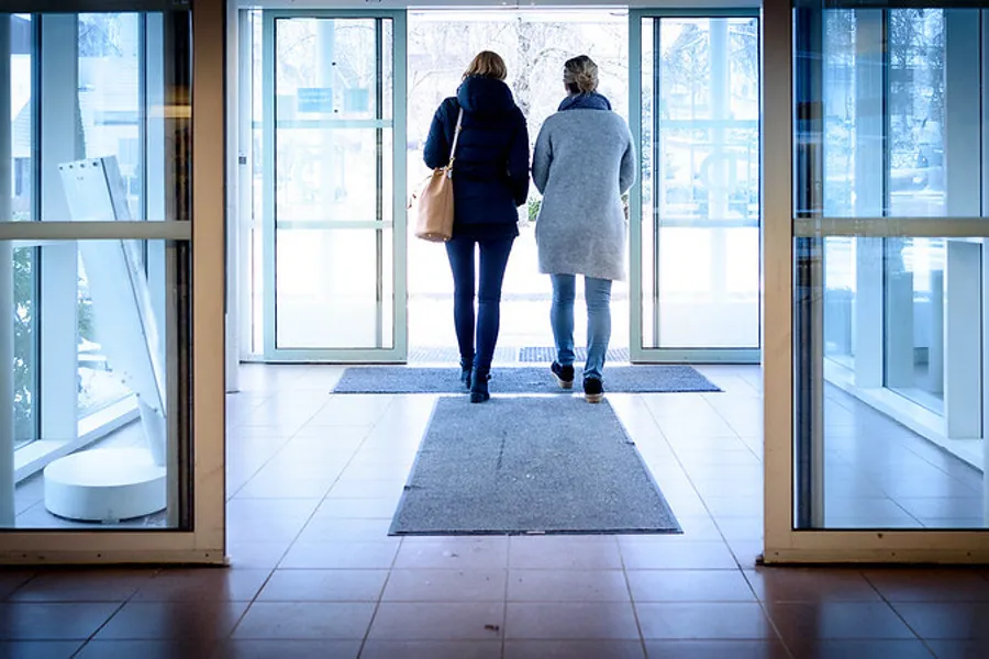 Et par kvinner som går gjennom en bygning