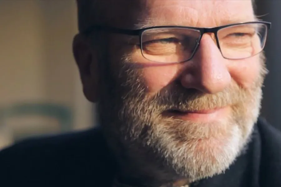 A man with a beard and glasses