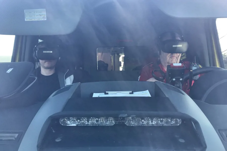 To ambulansemedarbeidere simulerer en ambulansetur med VR-briller.