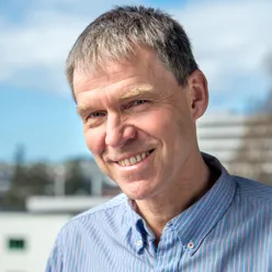 En mann som smiler til kameraet